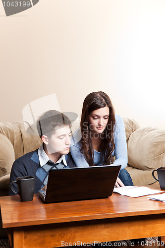 Image of Couple paying bills by online banking