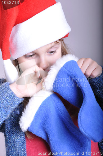 Image of child looking for a Christmas present