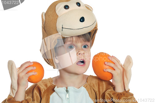 Image of monkey child with oranges