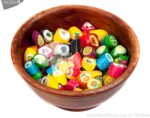 Image of Varicoloured lollipop in brown wooden plate