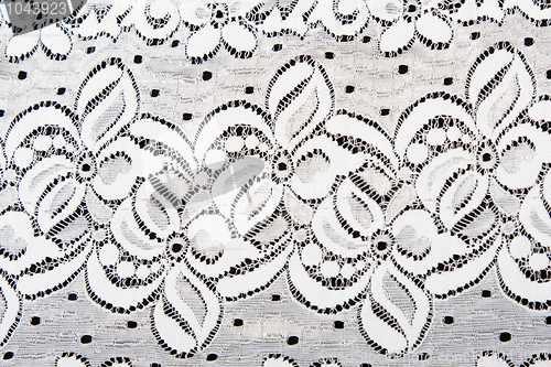 Image of White lace with pattern in the manner of flower