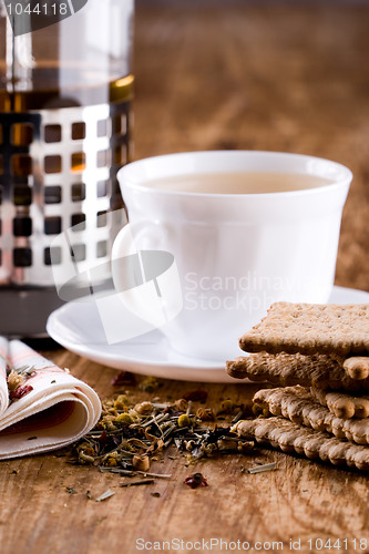 Image of cup of herbal tea and some fresh cookies 