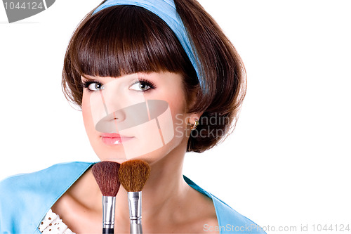 Image of woman with two make-up brushes 