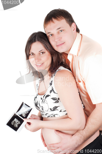 Image of Couple holding a sonogram of their child