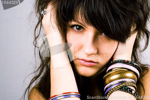 Image of young brunette lady with bracelets