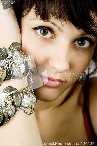 Image of young brunette lady with bracelets