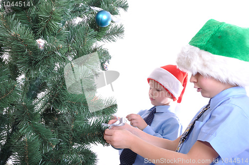 Image of boys decorating a Christmas tree