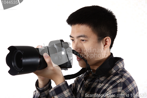 Image of Young male photographer at studio, isolated on white 