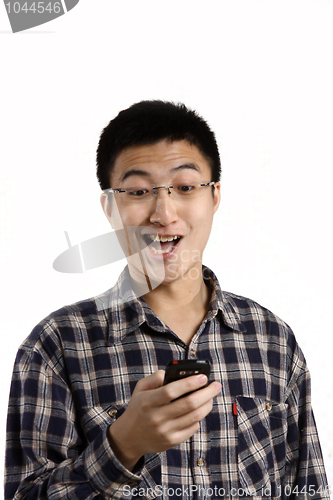 Image of casual man smiling feel surprised on a mobile phone isolated ove