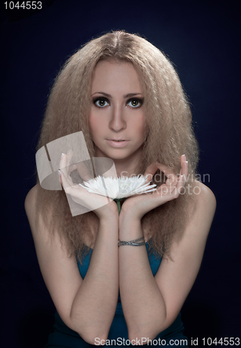 Image of woman meditating holding the big white flower