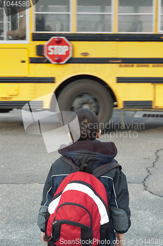 Image of a toddler waiting to catch the school bus