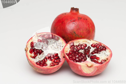 Image of fresh cut pomegranate on a white background