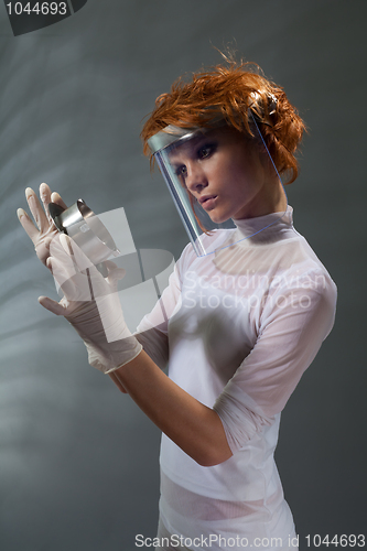 Image of Scientist woman examine metal part concept