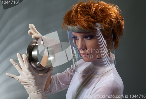 Image of Futuristic woman examine metal detail