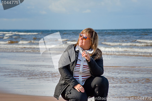 Image of Woman relaxing at the sea.