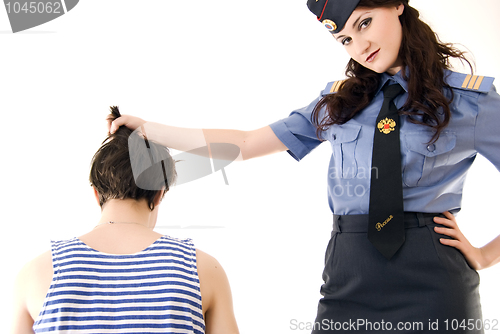 Image of Young woman in police uniform and a criminal