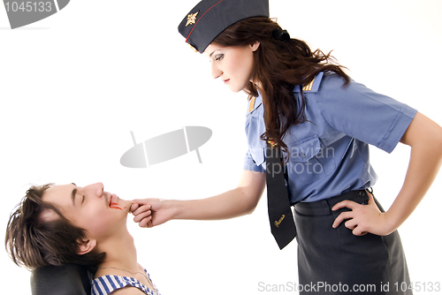 Image of Young woman in police uniform and a criminal