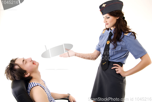 Image of Young woman in police uniform and a criminal