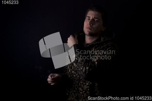 Image of portrait of a young man with cigarette  