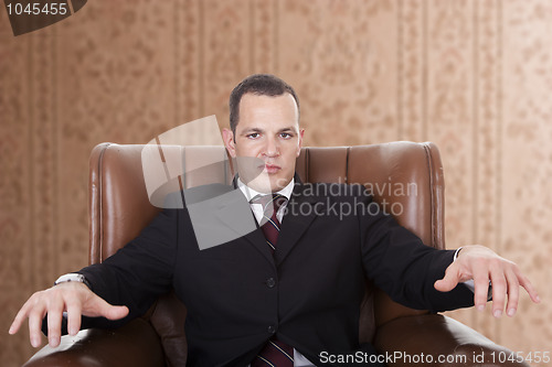 Image of Businessman upset seated on a chair,