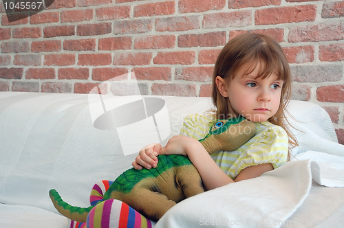 Image of child with a toy dinosaur