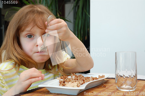 Image of child eating boild buckwheat