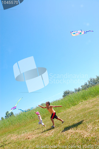 Image of kids flying kites high up