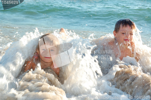 Image of children in waves on the beach