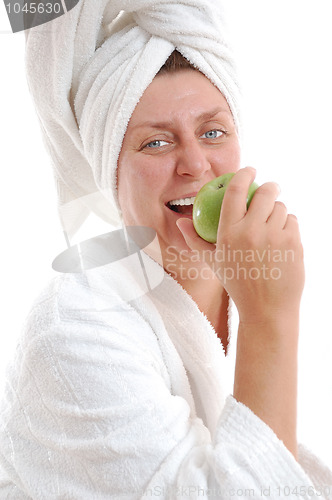 Image of matured adult smile woman with an apple