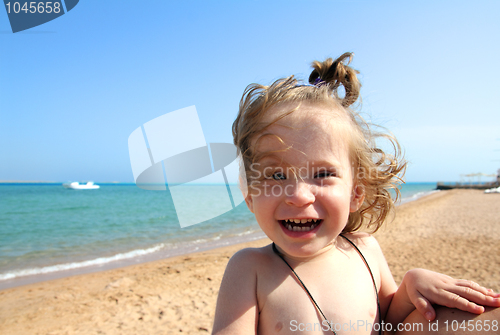 Image of laughing little girl on beach