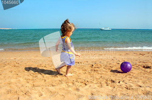Image of girl playing with ball on beach
