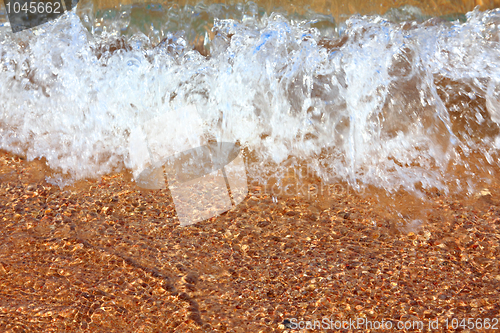 Image of sea waves and gold sand close-up