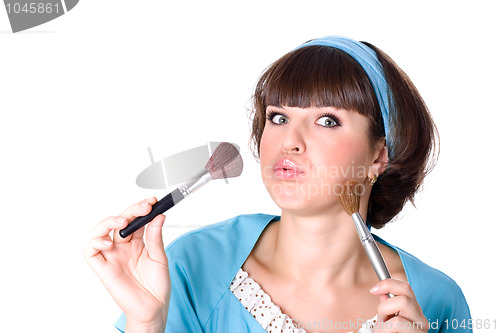 Image of brunet woman with two make-up brushes