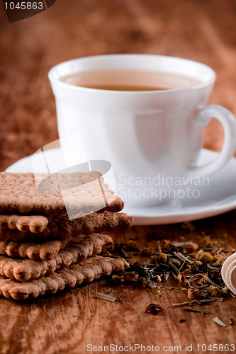 Image of cup of fresh herbal tea and some cookies 