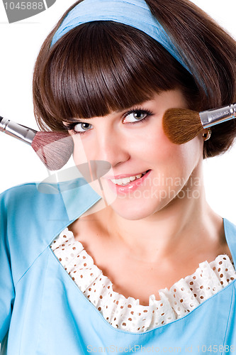 Image of brunet woman with two make-up brushes