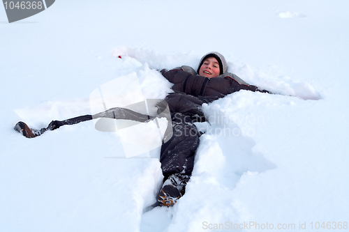 Image of Happy Boy Laying In Fresh Snow