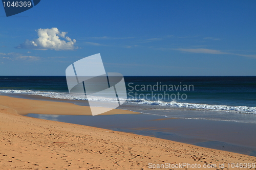 Image of Tranquil beach and a cloud