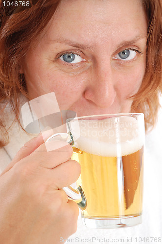 Image of mature adult woman drinking beer