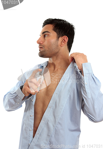 Image of Man spraying perfume cologne