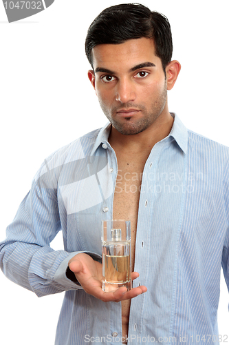 Image of Man holding perfume fragrance