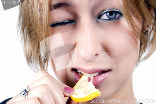 Image of girl eating a lemon  