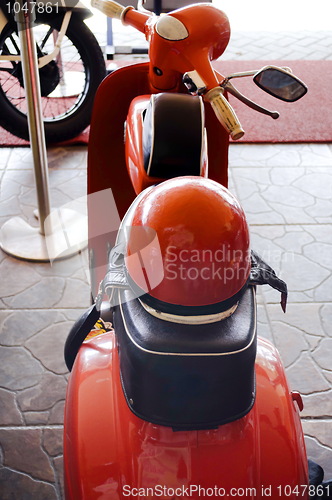 Image of  Italian old moped Vespa with helmet