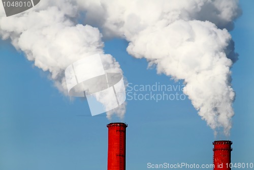 Image of two red pipes and smoke