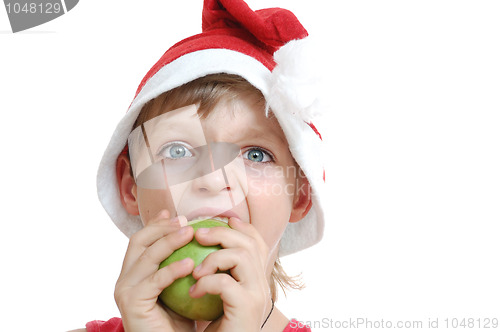 Image of Christmas boy biting an apple