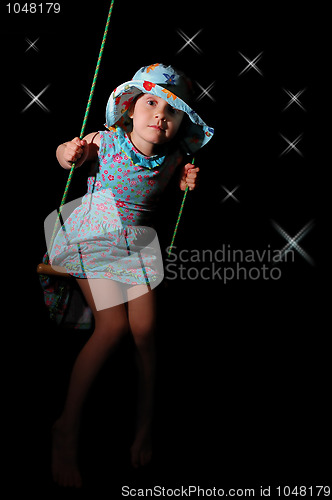 Image of swinging girl 