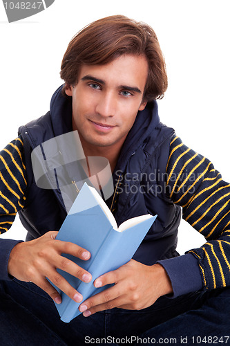 Image of man seated reading a book