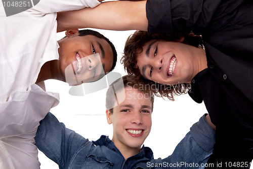 Image of three young man of different colors,looking to camera and smiling