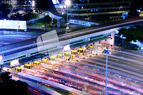 Image of blurred bus light trails in downtown night-scape 