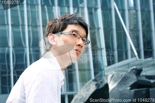 Image of business man on modern glass building background