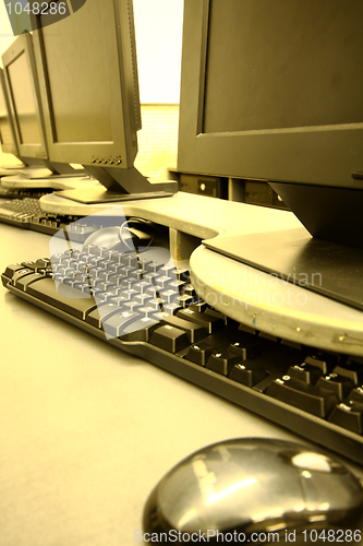 Image of workplace room with computers in row 